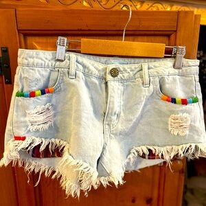 Show Me Your MuMu Light Wash Denim Fringe Shorts with Rainbow Trim